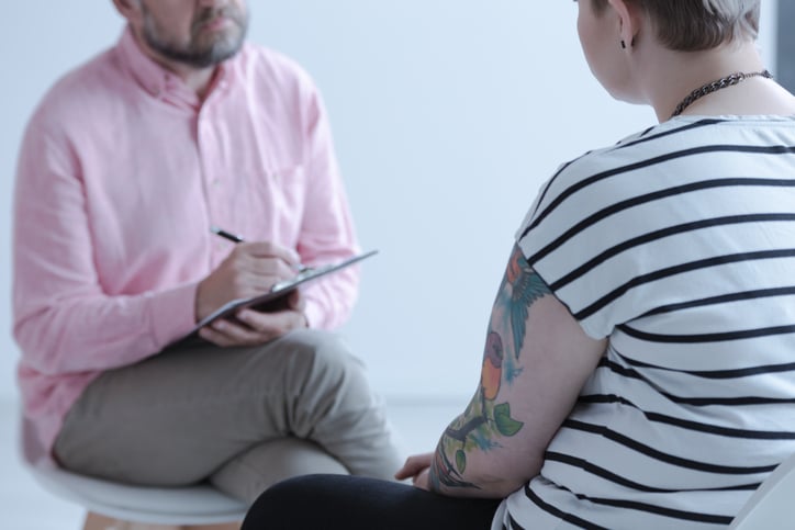 Patient undergoing CPT (Cognitive Processing Therapy) in Denver, CO. The individual is engaged in a therapeutic session, working with a mental health professional to address and process challenging thoughts and emotions.